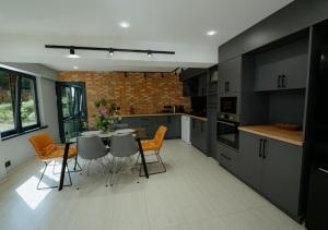 a large kitchen with a table and chairs in it at "The Nest" Premium Mountain Lodge with Alpine retreat & Sauna in Vanadzor