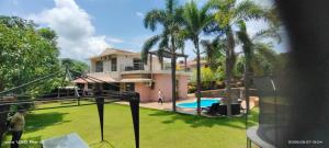 a house with a swimming pool and palm trees at Holiday villa in Lonavala