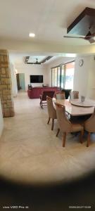a large living room with a table and chairs at Holiday villa in Lonavala