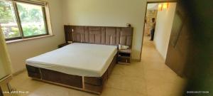 a bedroom with a bed and a person standing in a doorway at Holiday villa in Lonavala