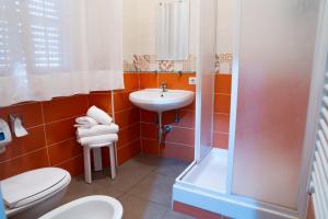 a bathroom with a sink and a toilet and a shower at Albergo San Lorenzo in Grosseto