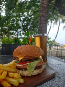 a hamburger and french fries and a glass of beer at Portia Hotel & Spa - Beachfront in Dhiffushi