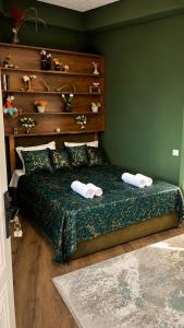 a bedroom with a bed with two towels on it at Sheki Secret Garden Boutique Hotel & Guest House in Sheki