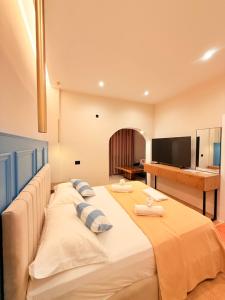 a large bed in a room with a television at Rida Village Hotel Ksamil Island in Ksamil