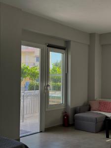 a room with a door with a window and a couch at Nefeli's apartment in Vonitsa