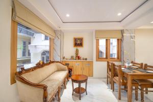 a living room with a couch and a table at Treebo Sheel, Near Mall Road in Shimla