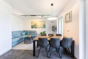 a living room with a dining room table and a couch at LUX Dolce Vista Apartment - Portorož in Portorož