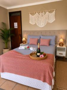 a bedroom with a bed with a bottle of wine at Alisios Kite Lodge in Cumbuco +21 photos