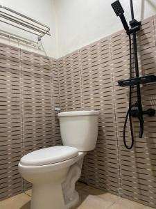 a bathroom with a toilet and a camera at Sekar Homestay in Bantul
