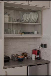 a kitchen with a counter with plates and cups at Dimitra Suites in Pythagoreio