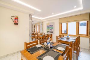 a dining room with a table and chairs at Treebo Sheel, Near Mall Road in Shimla