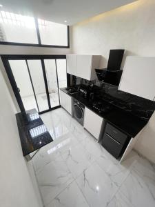 a kitchen with a stove and a microwave at La Casa Residence in Dakar