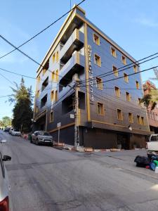 a large building on the corner of a street at KA Hôtel Dely Ibrahim in Deli Ibrahim