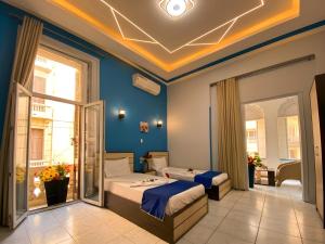 a bedroom with two beds in a room at Royal Hostgram and Suites in Cairo +17 photos