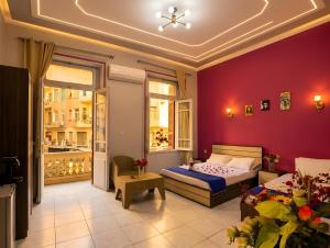 a bedroom with a bed and a couch in a room at Royal Hostgram and Suites in Cairo