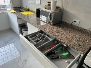 a kitchen counter with a drawer filled with tools at Austral Premium in Comodoro Rivadavia