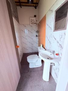 a bathroom with a white toilet and a sink at Khaosok Campsite in Khao Sok National Park +55 photos