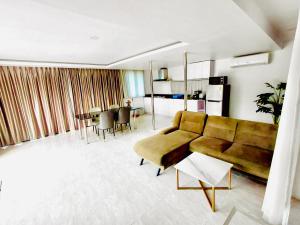 a living room with a couch and a table at Baan Golden Resort & Residences in Sam Roi Yot