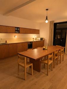 a kitchen with a large wooden table and chairs at Maison Bruxelles in Brussels