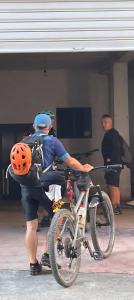 a man with a helmet on a bike at Hotel Reci in Peshkopi