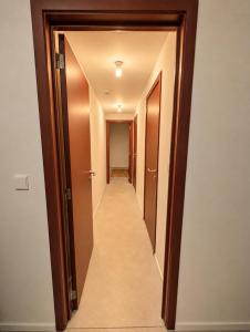 a hallway with two doors and a hallway leading into a room at Maison Bruxelles in Brussels
