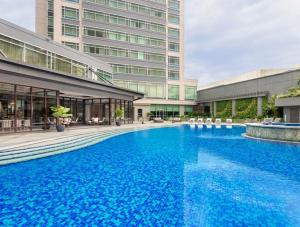 a large swimming pool in front of a building at Ascott Makati in Manila