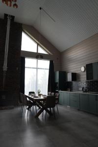 a dining room with a table and chairs in a kitchen at Chalet 1391 in Ryskulovo