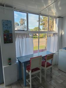 a dining room with a blue table and two chairs at Feather Foot Self catering Accommodation in Heidelberg
