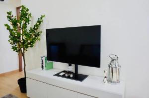 a flat screen tv sitting on top of a white cabinet at condoTip in Loei