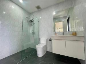 a bathroom with a toilet and a sink and a shower at condoTip in Loei