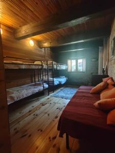 a bedroom with two bunk beds and a wooden floor at Rifugio Escursionistico Vernin in Fenils