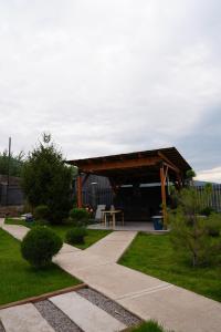 a pavilion with a picnic table in a garden at Chalet 1391 in Ryskulovo