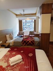 a hotel room with two beds and a window at Hotel The Dzong ! Gangtok in Gangtok