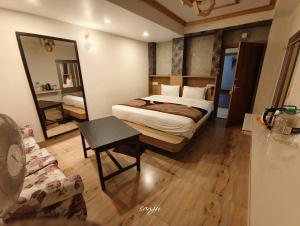 a hotel room with a bed and a mirror at Hotel The Dzong ! Gangtok in Gangtok