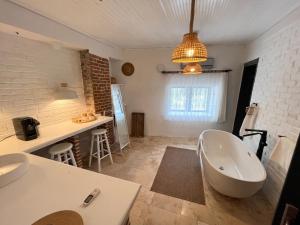 a bathroom with a bath tub and a sink at Attalos Suites Hotel in Bergama +131 photos