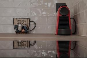 a shelf with a tea kettle and a cup on it at Dimitra Suites in Pythagoreio