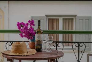 a table with a bottle of wine and two glasses at Dimitra Suites in Pythagoreio