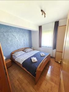 a bedroom with a bed with two towels on it at Apartment Love in Vlasic