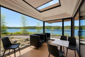 a room with large windows and a table and chairs at #41 Space Capsule 1-bdr in Parry Sound