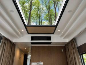 a skylight in the ceiling of a room with trees at #41 Space Capsule 1-bdr in Parry Sound