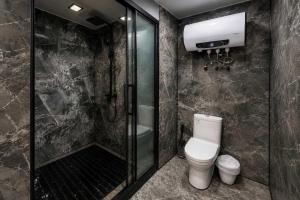 a bathroom with a toilet and a glass shower at #41 Space Capsule 1-bdr in Parry Sound