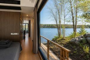 a bedroom with a view of a lake from a balcony at #41 Space Capsule 1-bdr in Parry Sound +7 photos