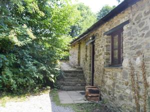 an old stone building with stairs and a window at Great Meadow in Kelly