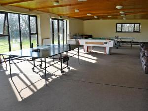 a room with a ping pong table and a pool table at Great Meadow in Kelly