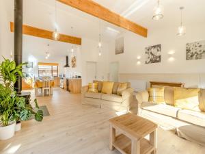 a living room with two couches and a table at Lime Lodge - Uk42547 in Llanwrthwl