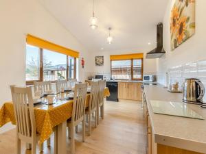 a kitchen with a table and chairs in a kitchen at Lime Lodge - Uk42547 in Llanwrthwl +16 photos