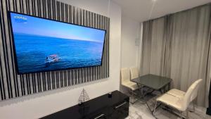 a room with a flat screen tv hanging on a wall at Victory in Alicante +18 photos