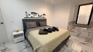 a bedroom with a bed with towels on it at Victory in Alicante