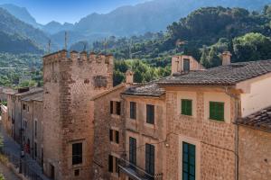 a group of buildings with mountains in the background at Can Mayol in Fornalutx