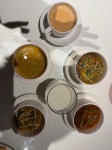 a table with four bowls of food and a cup of coffee at THREE TREE Signature Hotel-G7 Markaz Islamabad in Islamabad